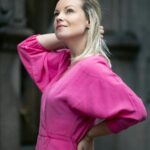 confident woman in pink dress- midlife transformation