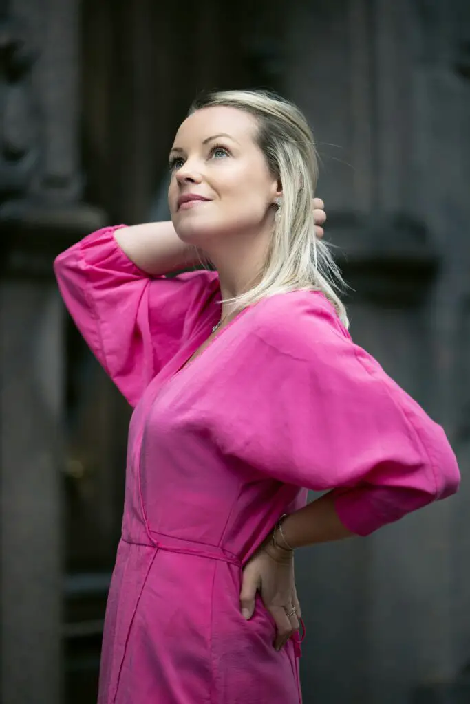 confident woman in pink dress- midlife transformation